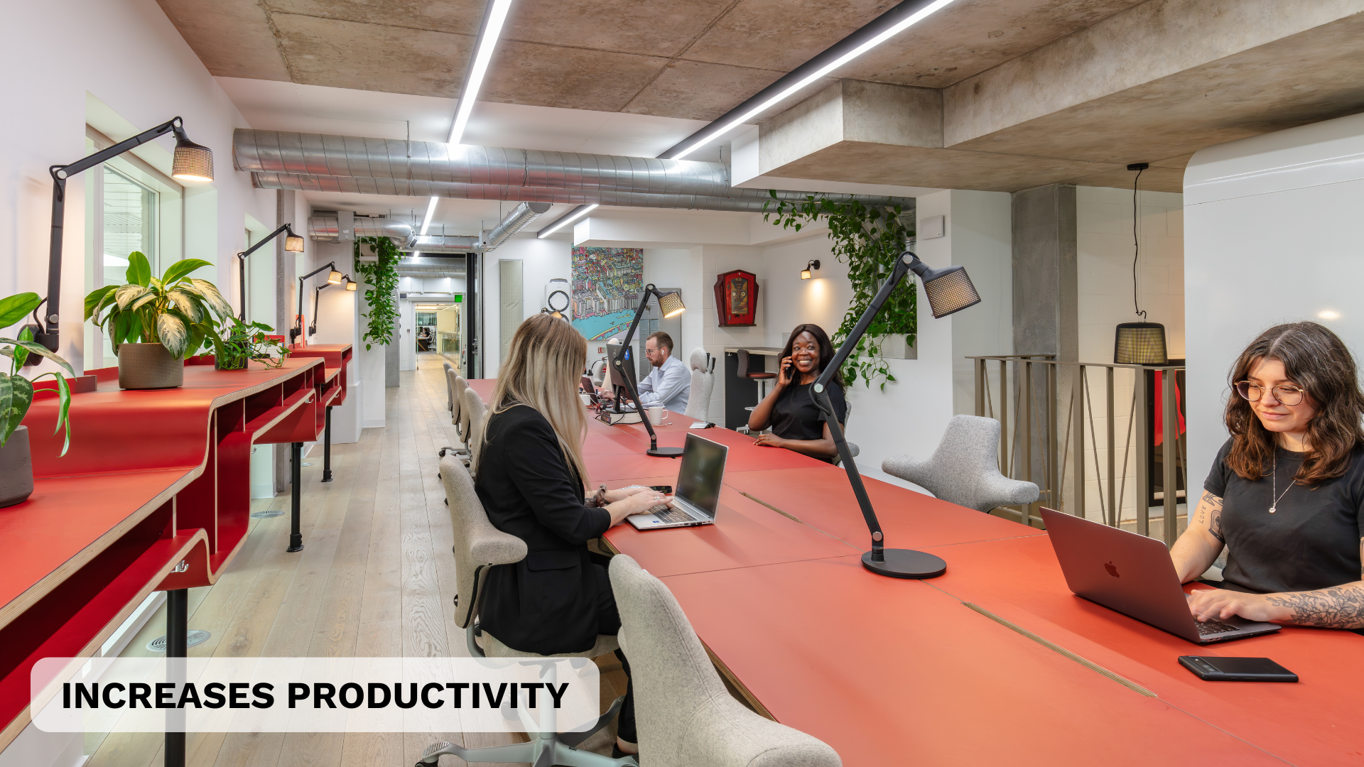 Four people working in a biophilic coworking space in London
